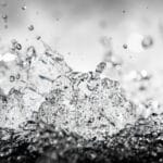 fine art photography of splashing water drops looking like a crystal cosmos