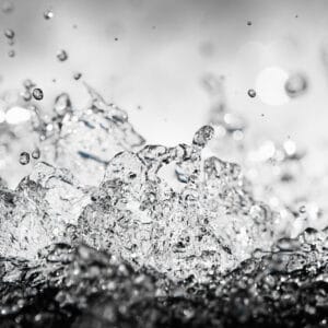 fine art photography of splashing water drops looking like a crystal cosmos