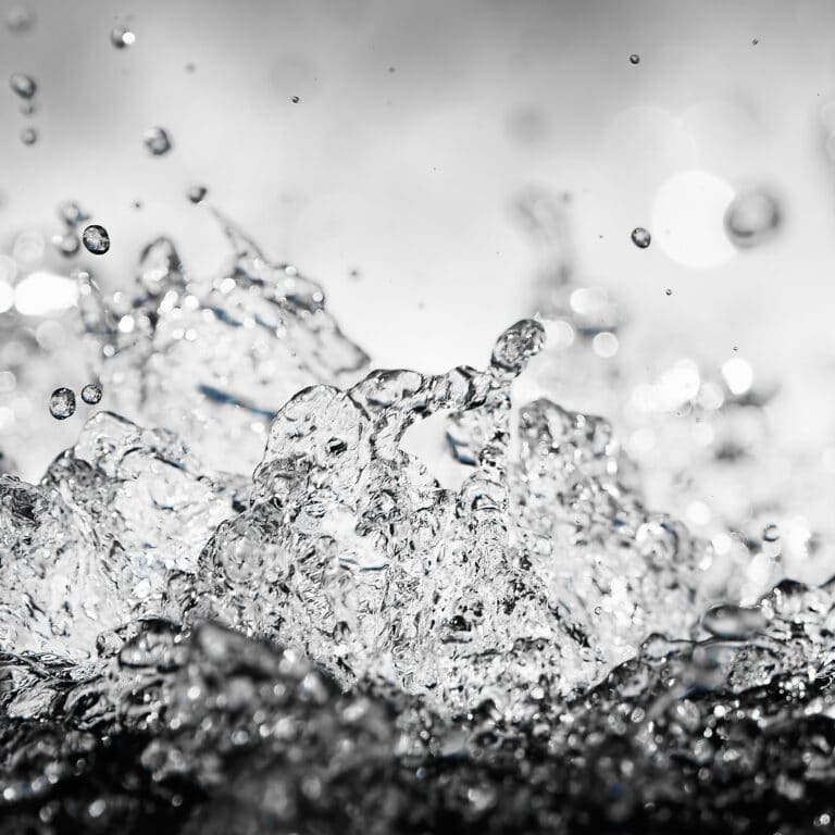 fine art photography of splashing water drops looking like a crystal cosmos