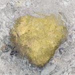 heart shaped stone shimmering through the water surface