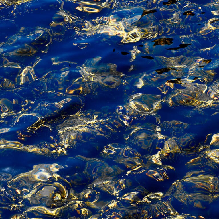 structures and patterns on water surface, colored in blue and gold, looking like Lapislazuli