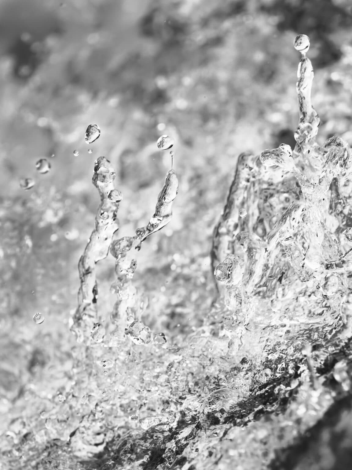 fine art photography of splashing water drops looking like Jupiters surface