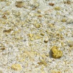 stones and pebbles in water, shimmering like gold nuggets